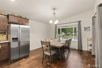 Dining space surrounded by windows, bringing in natural light and outdoor views.