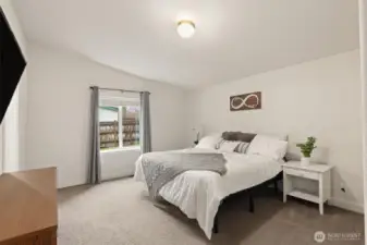 Spacious primary bedroom with natural light and a clean, functional layout.