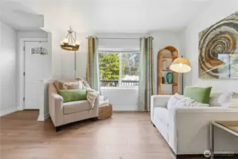 Front living room is complete with fresh paint, durable vinyl plank flooring and new light fixtures.