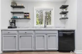 Kitchen window overlooks the back yard.