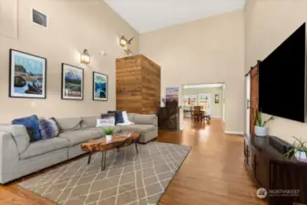 The reclaimed wood wall has a ledge to access the HUGE storage loft above the main spaces. This was formerly a lofted primary suite, and could possibly be repurposed for additional living space if you add stairs and a larger door! Otherwise, you can keep it as a wonderful storage space (accessible with a ladder).