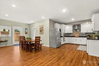 Room to roam! This kitchen and dining area has so much space for cooking, hosting, and play!