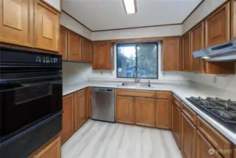 Kitchen with as wall oven, stainless steel dishwasher, gas cooktop