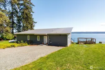The fenced garden, raised beds, paver patio with a propane fire pit, and a solar-lit path to the terrace create your own outdoor sanctuary
