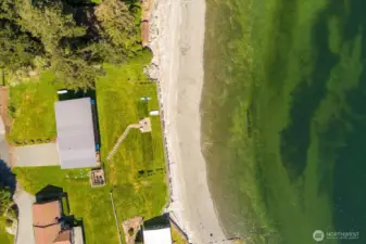 With tidelands hosting an active oyster farm included! See the Oyster farm in the dark shadow closest to the beach in front of the home.