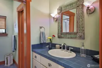 3/4 bath with a pocket door separating the shower from the vanity.