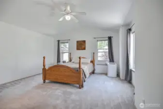 The spacious primary bedroom has vaulted ceilings.