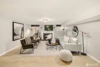 The lower level recreation room with gas fireplace makes a great space for cozy gatherings or movie nights.
