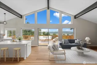 The great room comes alive -- open to the kitchen island and slider to the deck