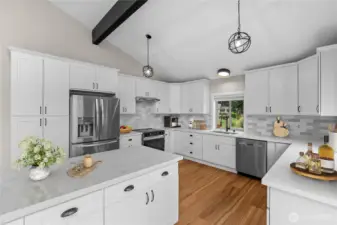 Quartz island, white shaker cabinetry, tile backsplash, and stainless steel appliances