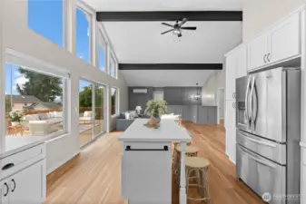 The kitchen opens to water views through the slider and deck beyond
