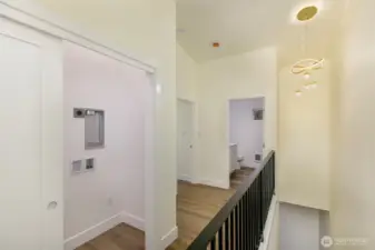 View of upstairs hallway and laundry room