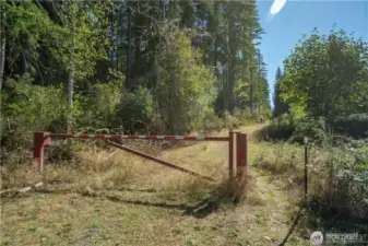 This property is worth walking the trail. Ideally located minutes to Hwy 302, access to essentials is easy while feeling completely private.  Park at the red gate and walk to the end of the road. The property will be on the left a sign.