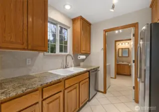 Kitchen has been updated with new granite countertops and recessed lighting.