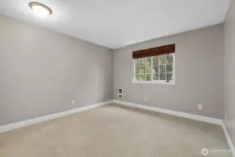 Primary bedroom overlooking backyard.