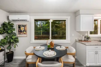 Eating space just off the kitchen with a view of the back yard and forest!