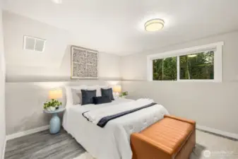 Large, lower bedroom with views of the forest as you drift into dreamland.