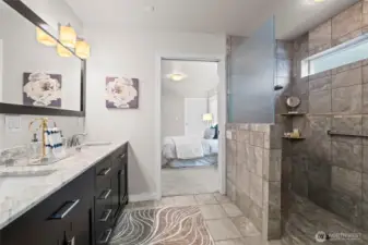 Primary ensuite bathroom boasts dual sinks, heated floors, and walk-in shower.