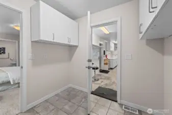 Cabinetry is on both sides of laundry room.