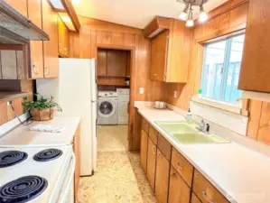 Efficient, galley kitchen conveniently located between the dining and utility areas.