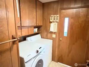 Washer, dryer, storage cabinetry and door out to the enclosed back porch.