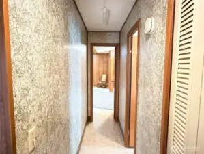 Back in the home looking toward the primary bedroom at the end of the hallway.