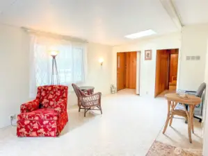 Front door & front closet on the left, and hallway to the second bedroom on the right.