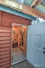 DOOR TO THE LARGER SHED WITH WASHER/DRYER AND STORAGE
