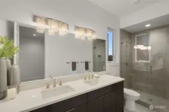 Primary bathroom features a double sink vanity and ceramic tile walk-in shower.