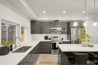 Sleek white quartz countertops, modern cabinetry, complete with stainless steel appliances.