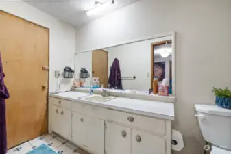 Main floor primary bathroom with large shower.  Door goes out to deck.