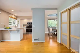 A view of the kitchen, dining room and behinf the door is a walk in pantry.