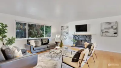 Gleaming hardwoods throughout the living room upstairs, wall of windows and cozy fireplace make this a great place to unwind at the end of the day.