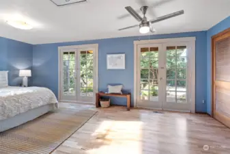 Primary bedroom with French doors to the back yard