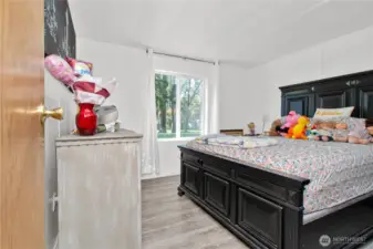 Bedroom 3 is light and bright, with soft laminate flooring that really makes the space shine—this room truly pops with warmth and charm.