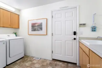 Mud room/Laundry room with utility sink allows for additional extra storage as well. Access to the garage from this drop zone.