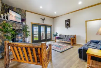 Living room, pellet stove with river rock front. Access to the back deck with a never ending view.