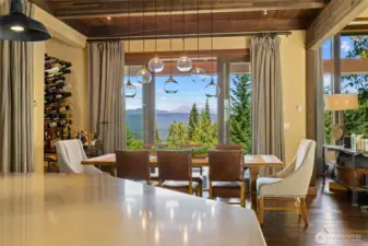 The view from the kitchen showcases double glass sliding doors off the dining room, beautifully accented by a statement light fixture from Restoration Hardware.
