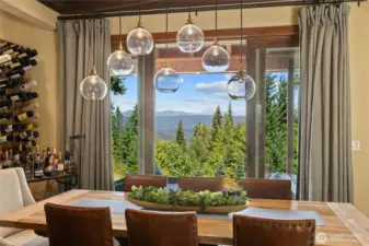 The dining room flows to a covered patio, enhanced by a custom built-in wine rack for convenient outdoor entertaining.