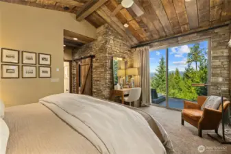"A barn door provides access to the primary bath, while double sliding doors open to a secluded patio.