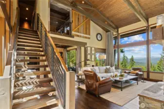 A beautifully crafted timber staircase, complemented by custom iron railings, leads to the upper floor.