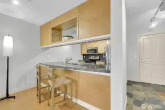 Share a seat at the kitchen peninsula.