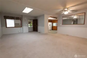 Very large combination dining room and living room with a walk in entry area to hang your coat and take your shoes off.  The skylight lets in natural light.  This home has both this living area as well as another family room area off the kitchen.