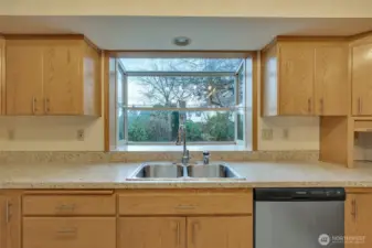 A lovely herb garden window sits above the sink for your favorite plantings.