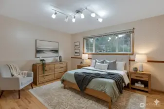 Spacious primary bedroom has a lovely window adding lots of natural light to the room.