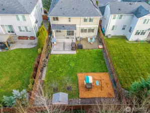 Aerial view of that amazing yard. Well kept neighbors on either side.