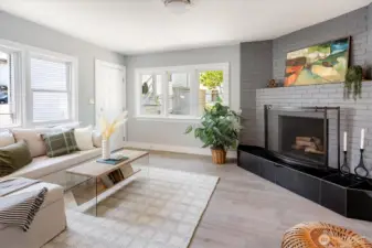 Private family room anchored by a classic fireplace effortlessly connects kitchen to courtyard. Photos from earlier listing in 2025.