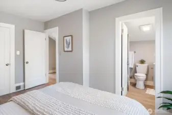 Primary bedroom offers calm and ease with an ensuite bath, walk-in, and discreet storage. Photos from earlier listing in 2025.