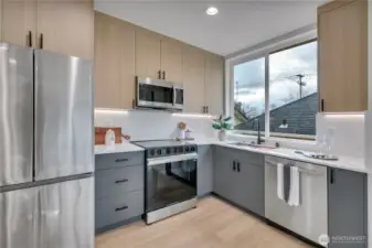 Kitchen with two tone cabinets with Undermount lights