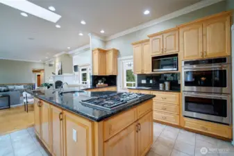 Dual ovens, over-sized refrigerator, countertop range; designed to really showcase the continuity of the inside and outside spaces.